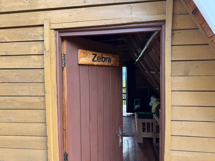 Zebra room door in a wooden cabin, Uganda.