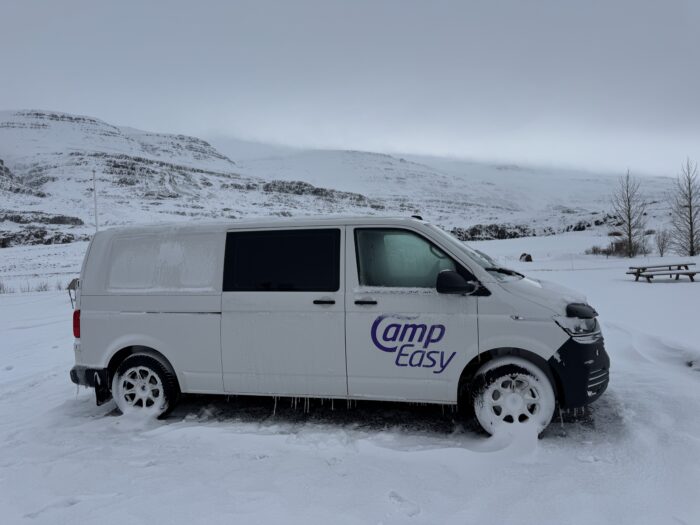 Camp Easy van in snowy Iceland landscape.