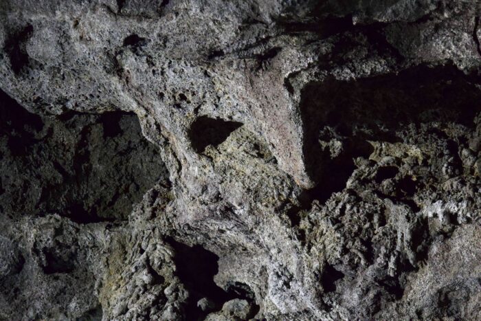 Textured volcanic rock formation in Iceland cave.